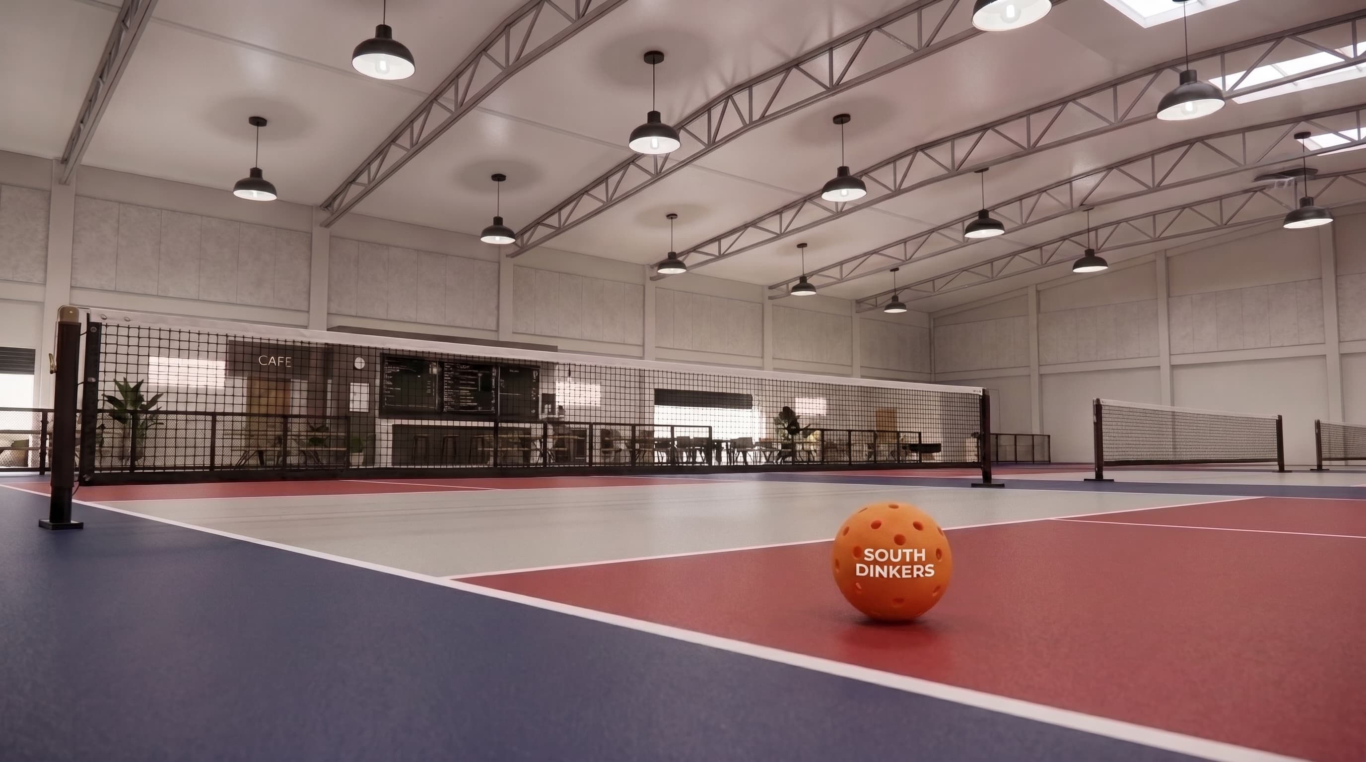 A South Dinkers ball resting on the baseline of an indoor court